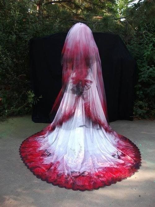 Red white and black veil wedding dress with a trail ombre .