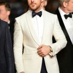 Ryan Gosling in a Ralph Lauren Purple Label ivory dinner jacket .