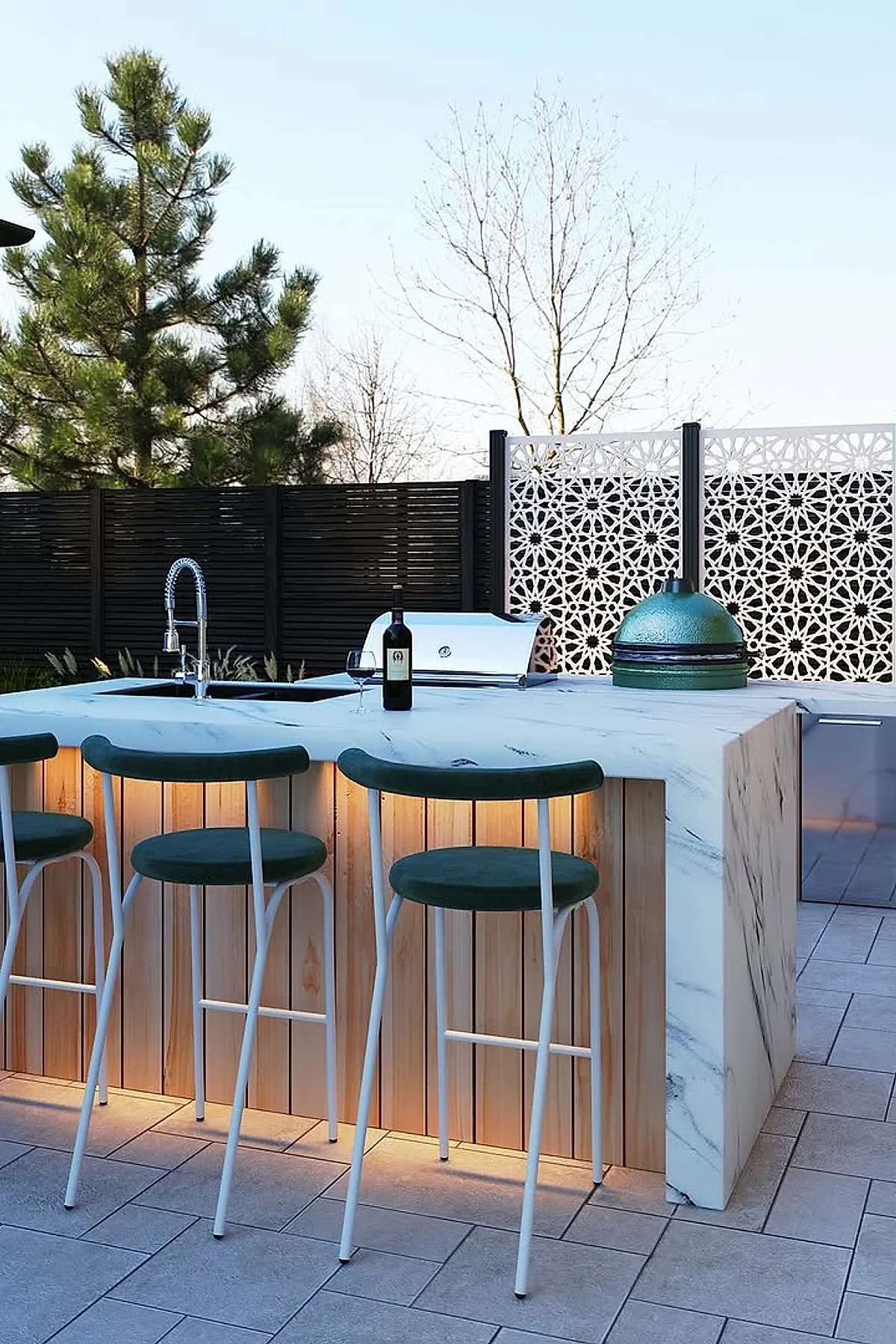 Outdoor area with black wood slats and white decorative metal privacy screens behind a marble kitchen island.