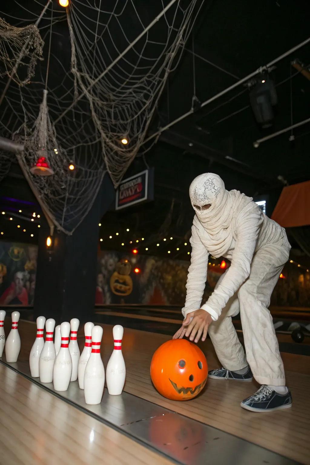 Strike down pins in the mummy bowling game.