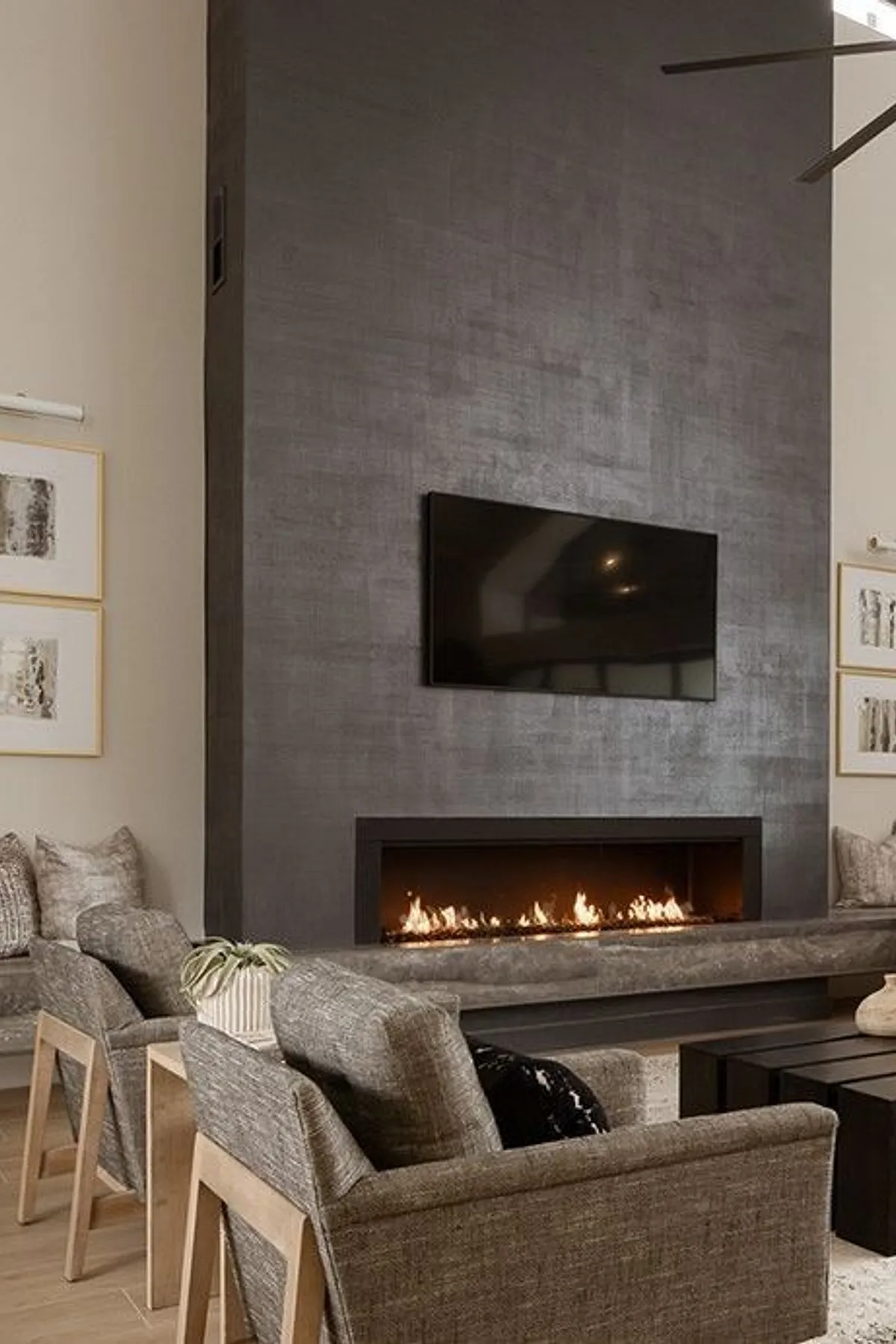 Living space focusing on distinctive tall dark fireplace