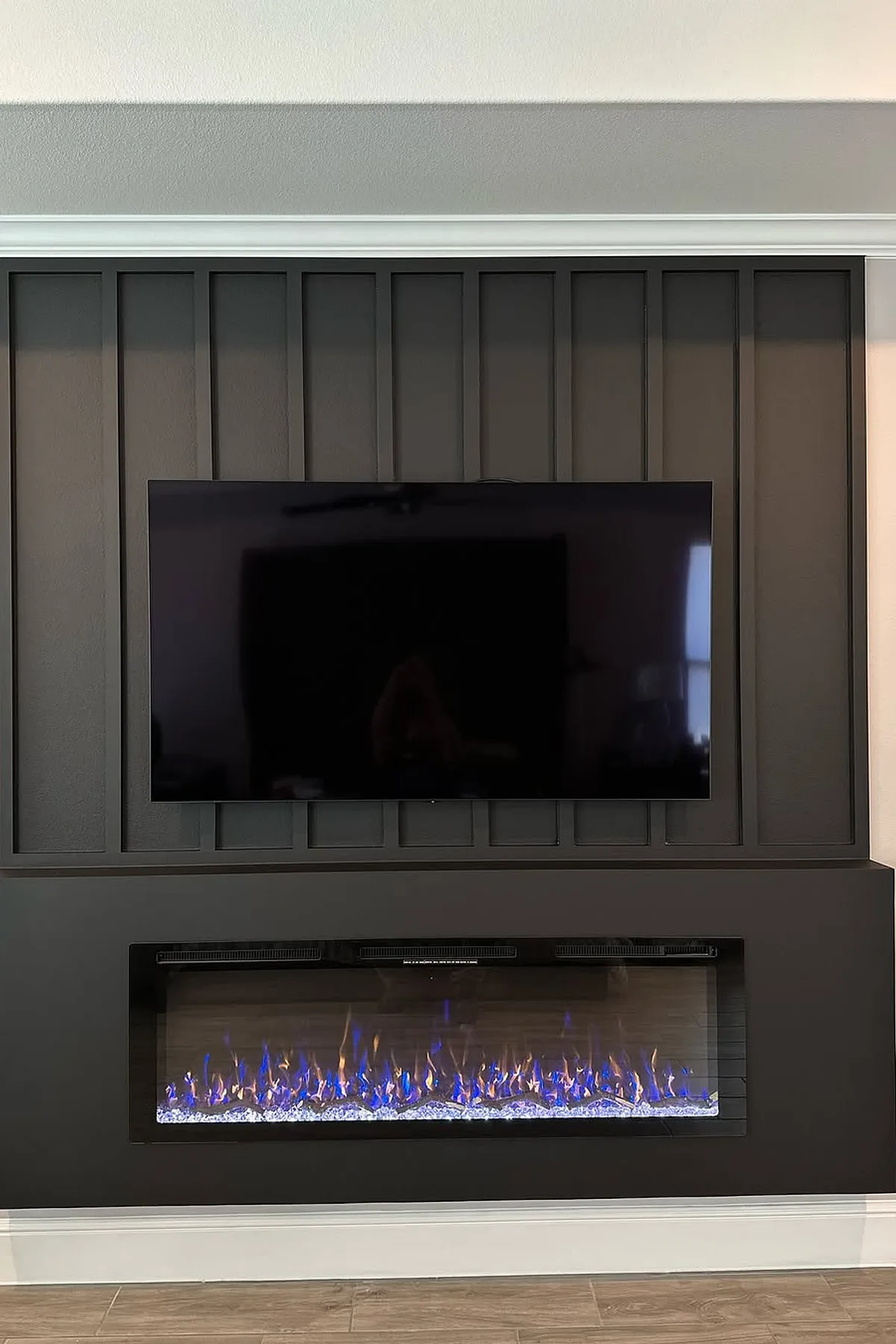 Contemporary space highlighting colorful fireplace and tv