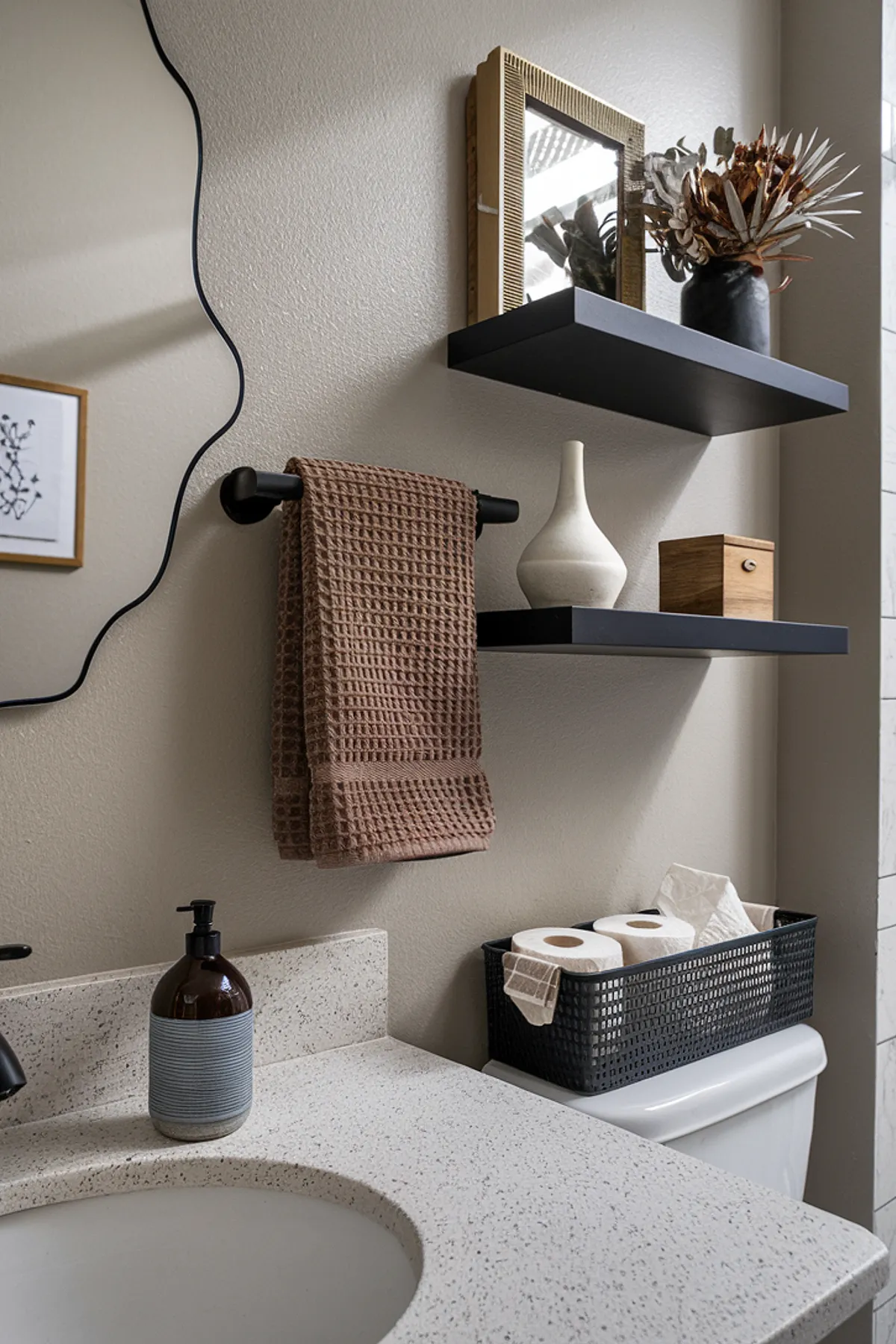 A modern bathroom showcasing earthy tones, stylish accessories, and organized decor.