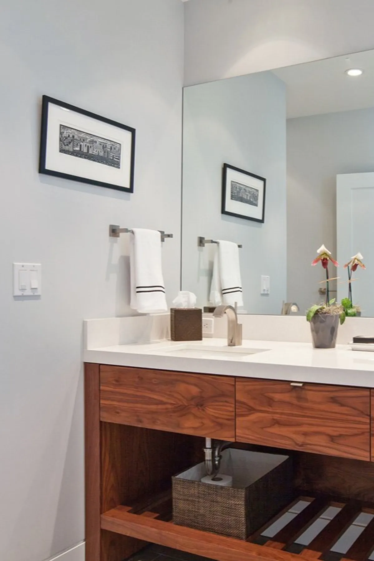 A modern bathroom featuring a sleek vanity and minimalist decor.