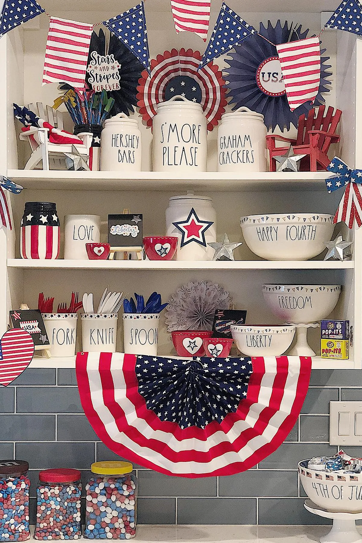A colorful kitchen shelf decorated for 4th of July with themed containers, stars, and patriotic accents.