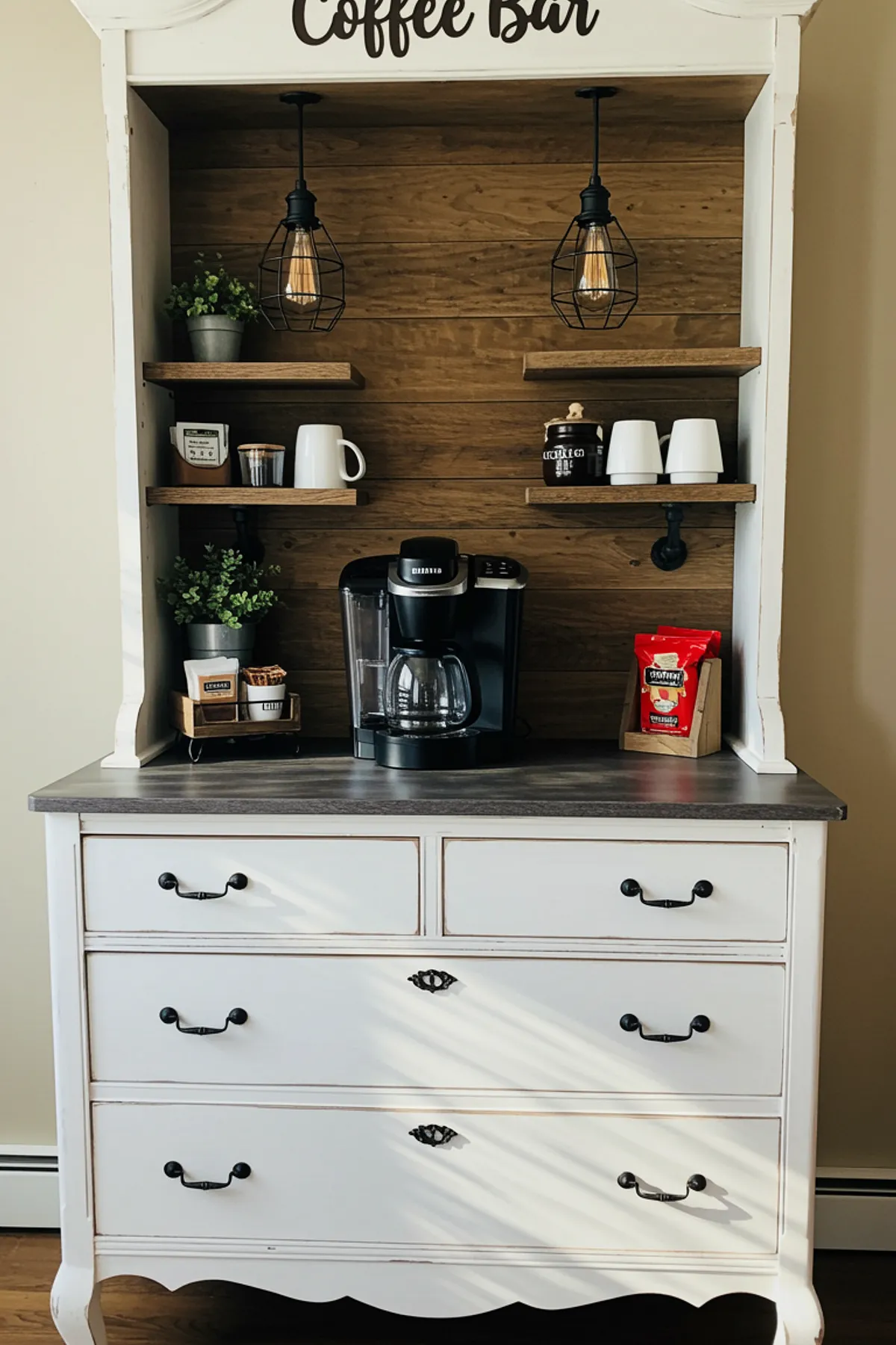 White hutch coffee station with Edison bulbs, wooden shelves, mugs, plants, and coffee machine.