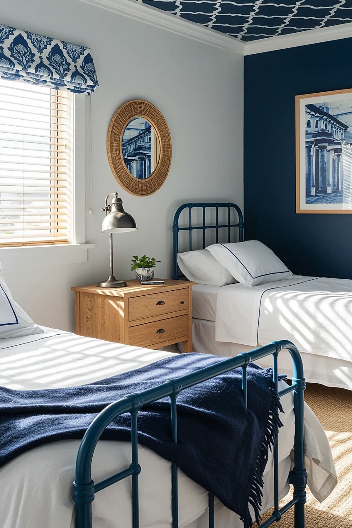 Bedroom with navy blue metal beds, white bedding, patterned ceiling, and wicker mirror.