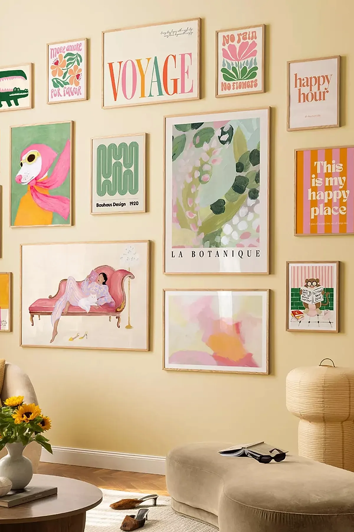 Living room gallery wall with colorful art pieces and playful typography, creating a vibrant focal point.
