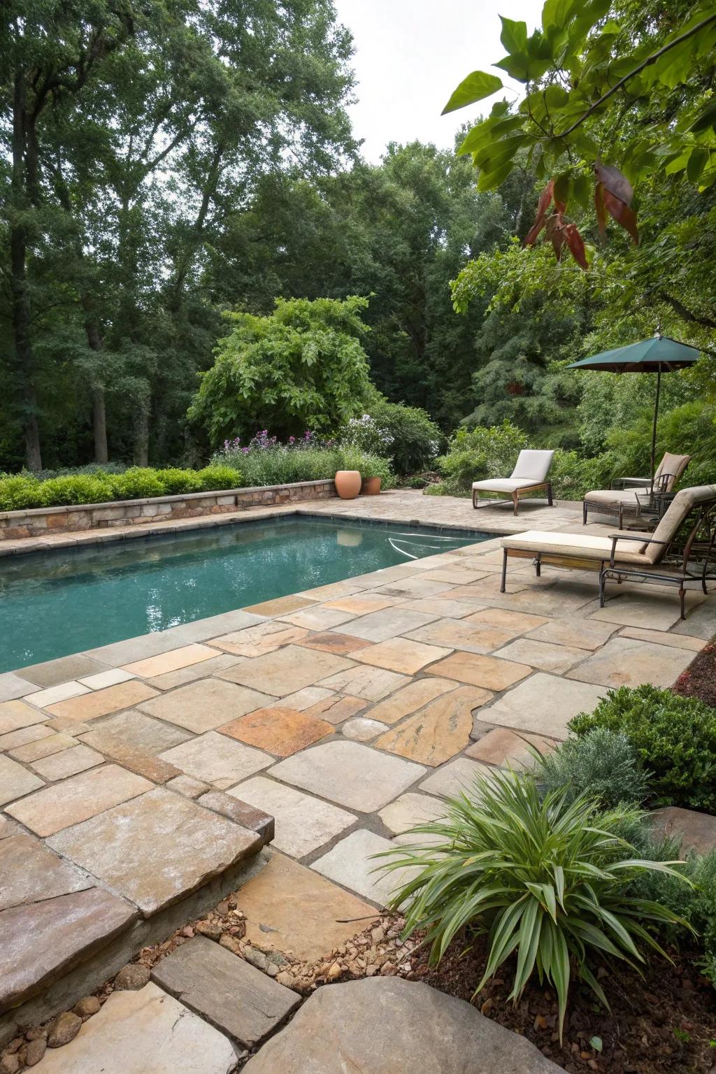 Earth stone tiles craft a timeless, organic elegance around this pool.