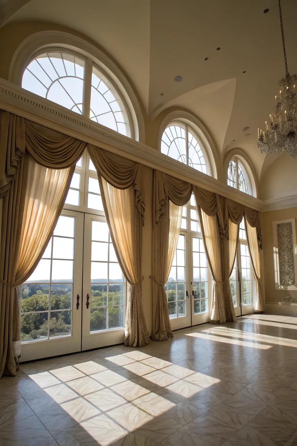 Grand living space featuring height-extending drapes on arched windows.
