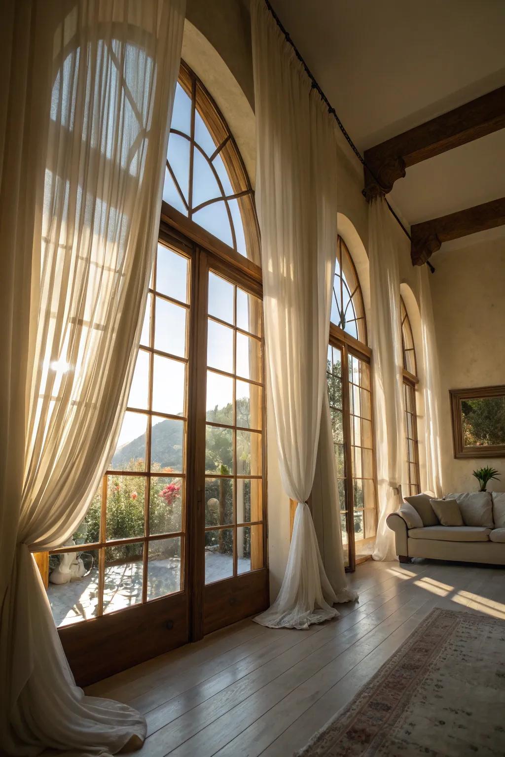 Sun-filled room featuring light filtering curtains on arched windows.