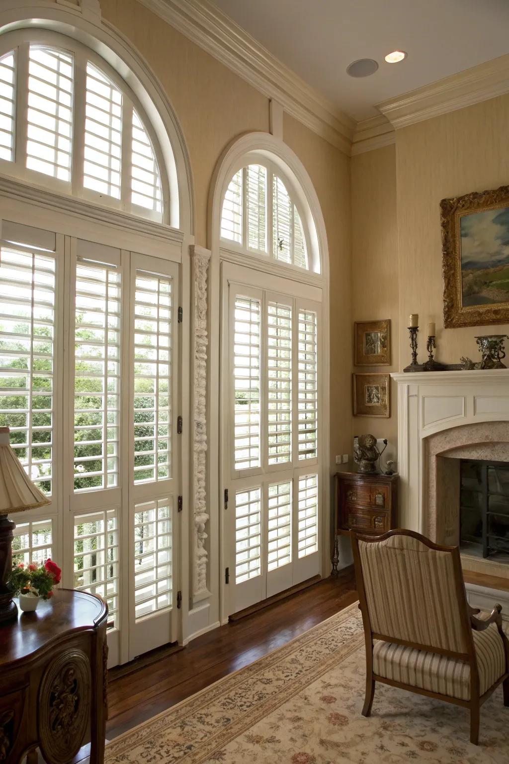 Traditional room featuring indoor louvers on arched windows.