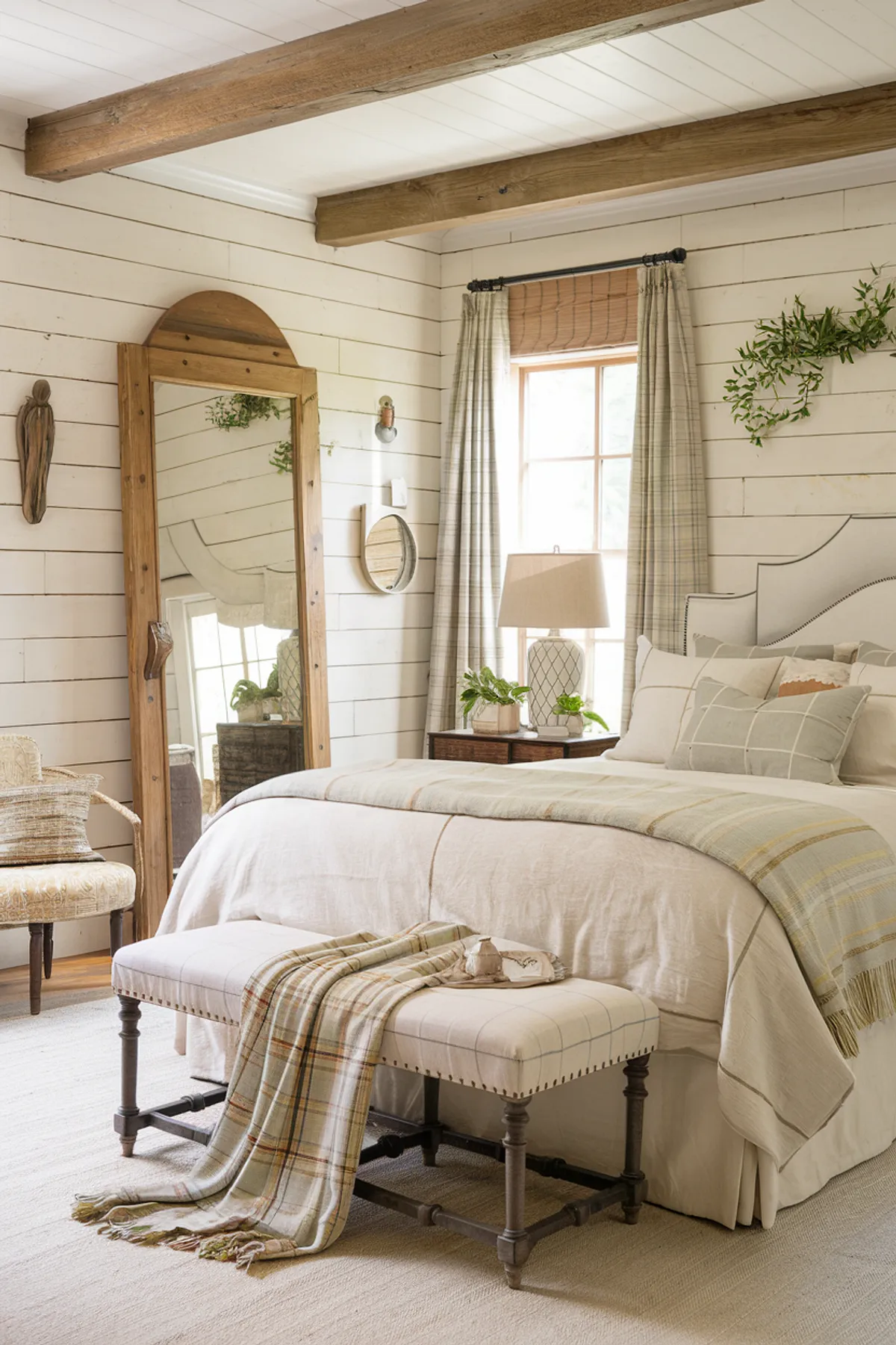 Cozy rustic bedroom with wooden beams, striped curtains, and beige bedding.